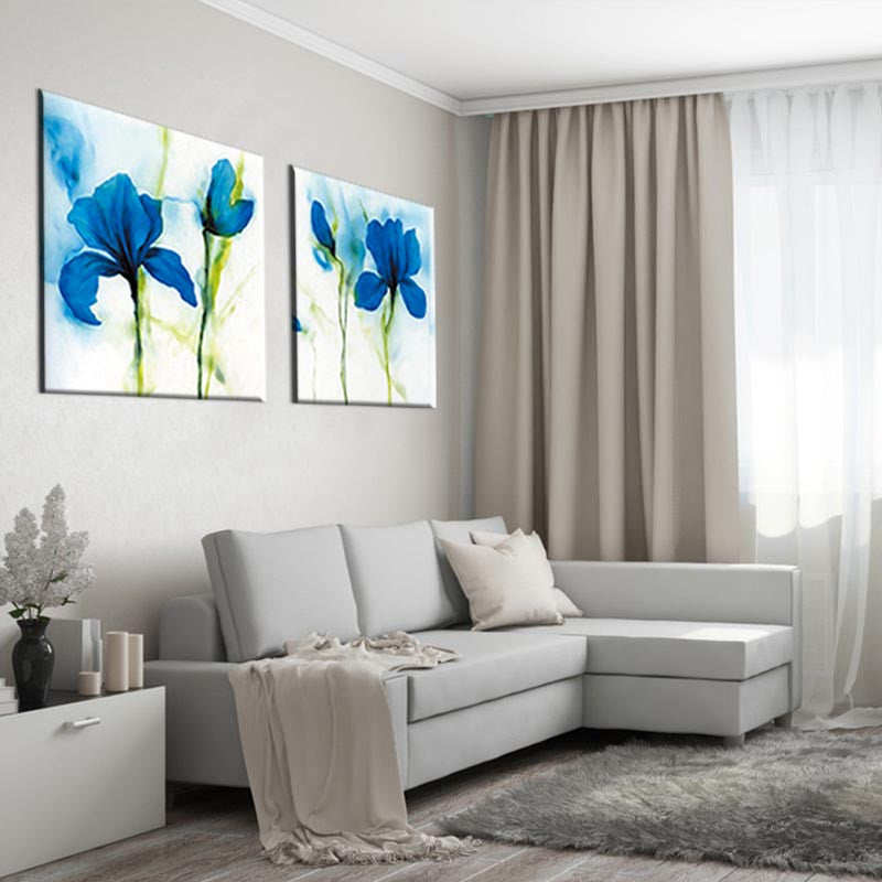 Blue Flower, Abstract Accents - 2 Piece canvas wall art featuring vibrant watercolor blue iris flowers on white background, displayed above grey sectional sofa in modern living room with neutral decor