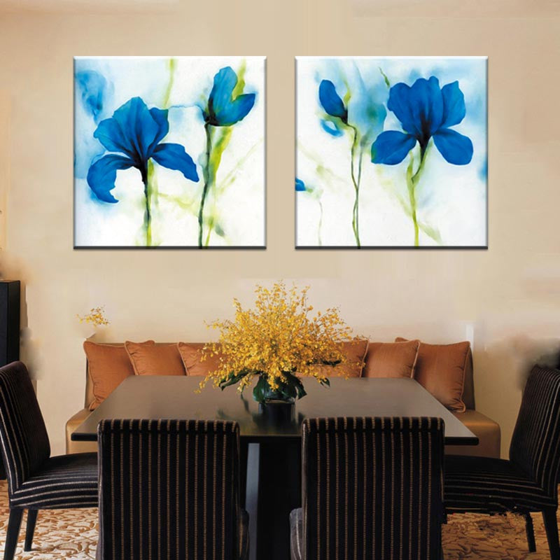 Blue Flower, Abstract Accents - 2 Piece canvas wall art featuring vibrant watercolor blue irises with green stems on white background, displayed as elegant dining room decor above brown sofa
