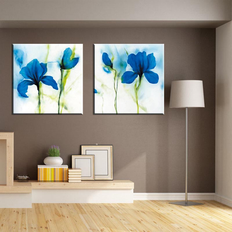 Blue Flower, Abstract Accents - 2 Piece canvas wall art featuring vibrant watercolor blue iris flowers with green stems on white background, displayed in modern living room with gray walls and wooden flooring