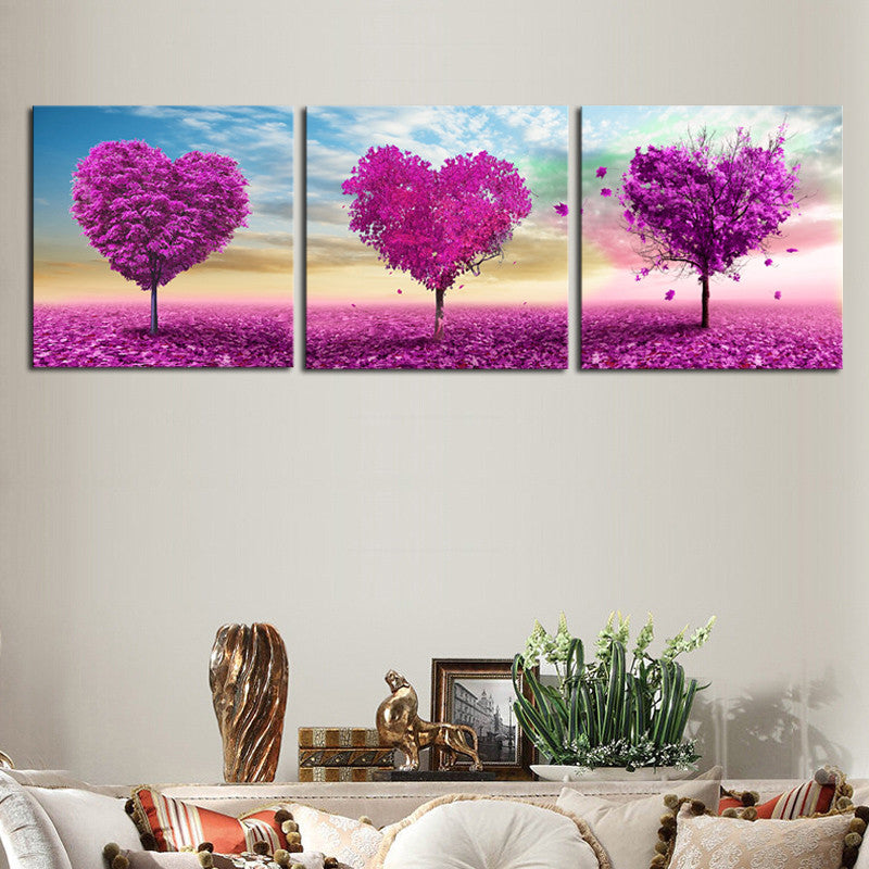 Purple Heart Trees canvas wall art featuring three vibrant purple heart-shaped trees against pastel sky, with falling leaves on pink field, modern romantic triptych panel set for home decor