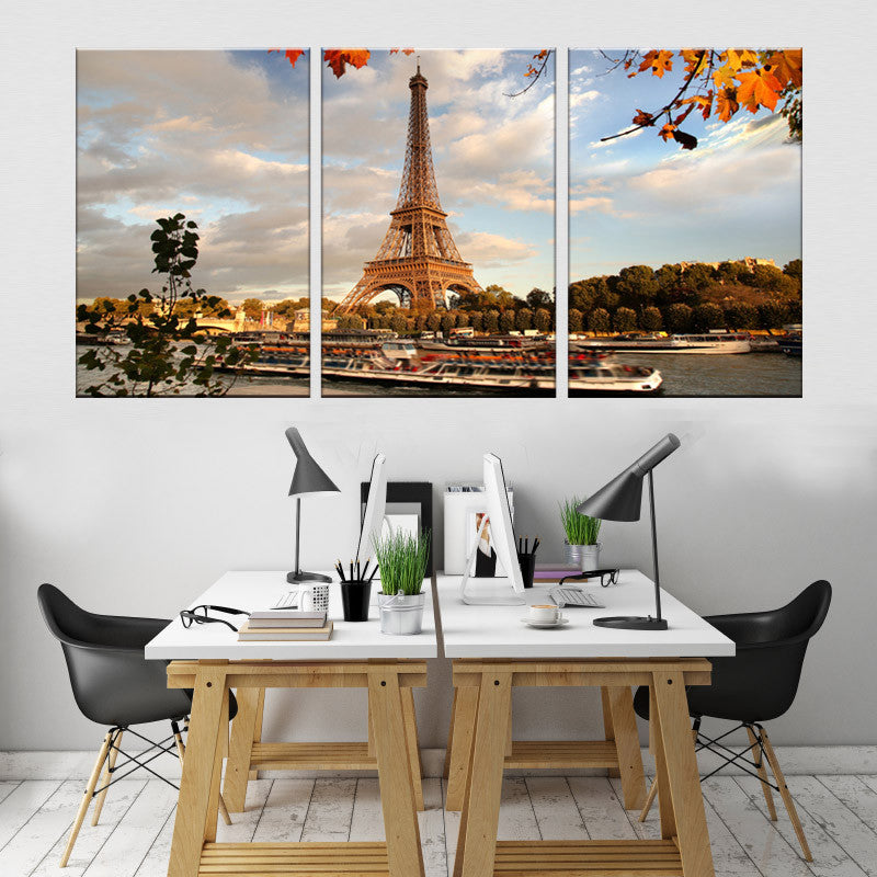 The Eiffel Tower Landscape 3-piece canvas wall art displaying iconic Paris landmark at sunset with autumn leaves, boats on Seine River, and golden clouds, perfect for modern home decor