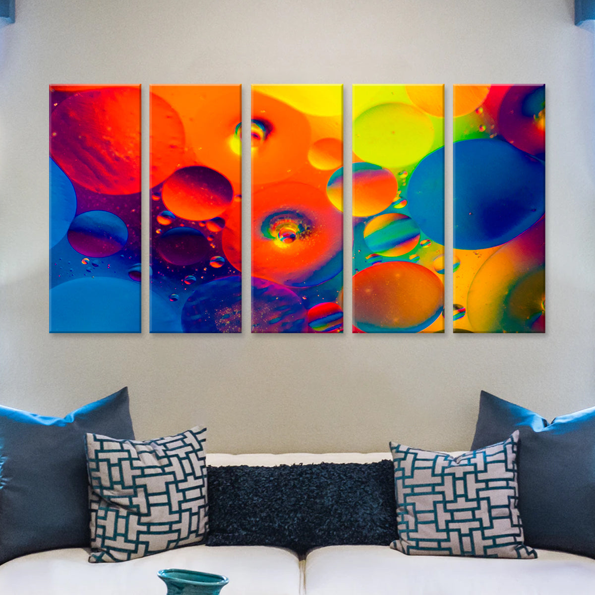 Colorful Bubbles - 5-panel canvas wall art featuring vibrant abstract photography of oil and water bubbles in rainbow colors of red, orange, yellow, and blue, mounted above a modern sofa with decorative pillows