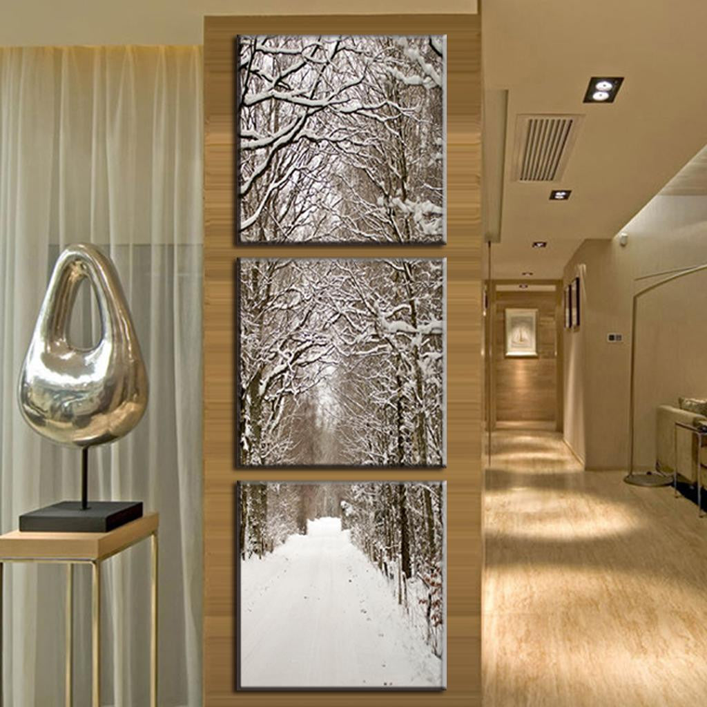Snowy Winter Boulevard - A serene three-panel canvas print showcasing a snow-covered tree-lined path, featuring bare branches dusted in white creating a stunning natural tunnel effect in black and white photography